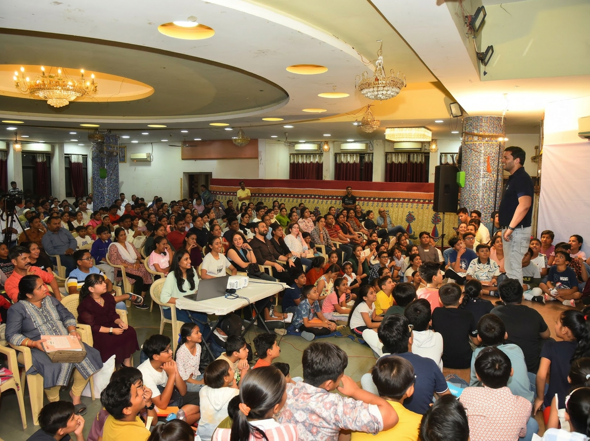 A packed hall gathered around a live educational talk