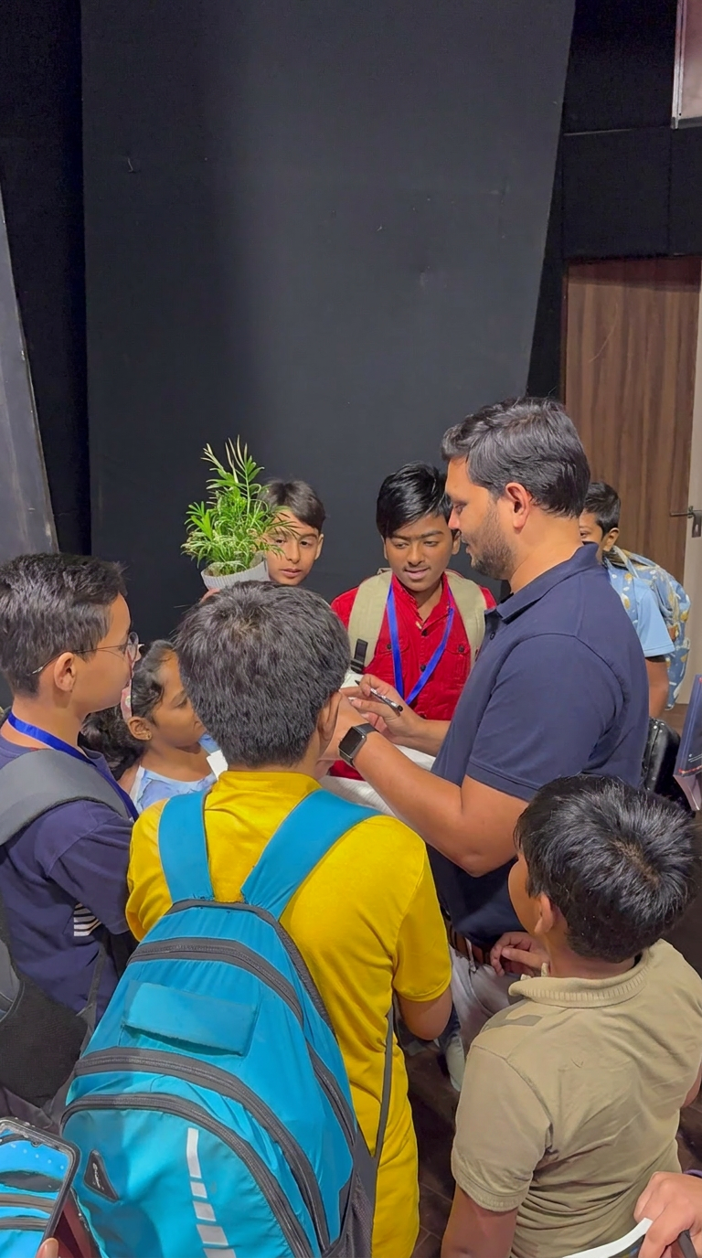 Close-up interaction between Sajan Shah and students backstage